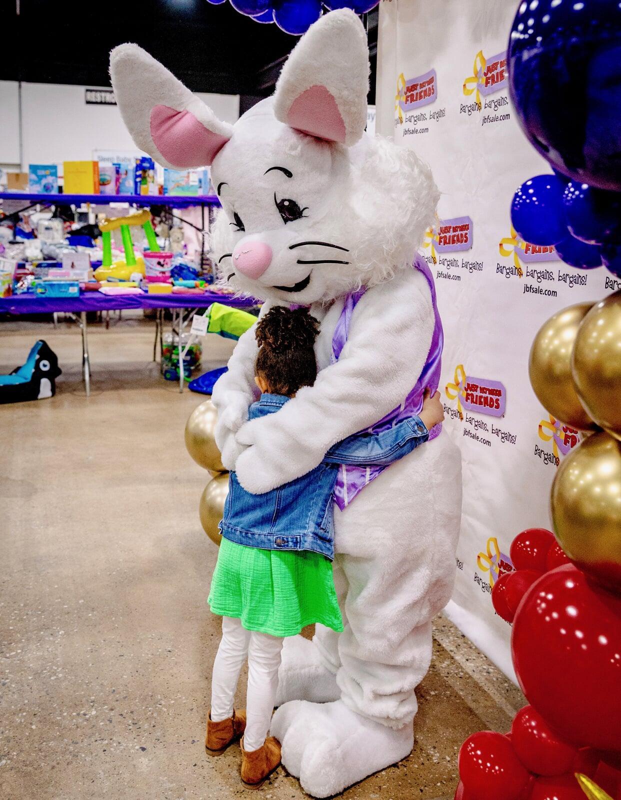 Easter Bunny and young girl hug each other at the JBF sale in Oaks