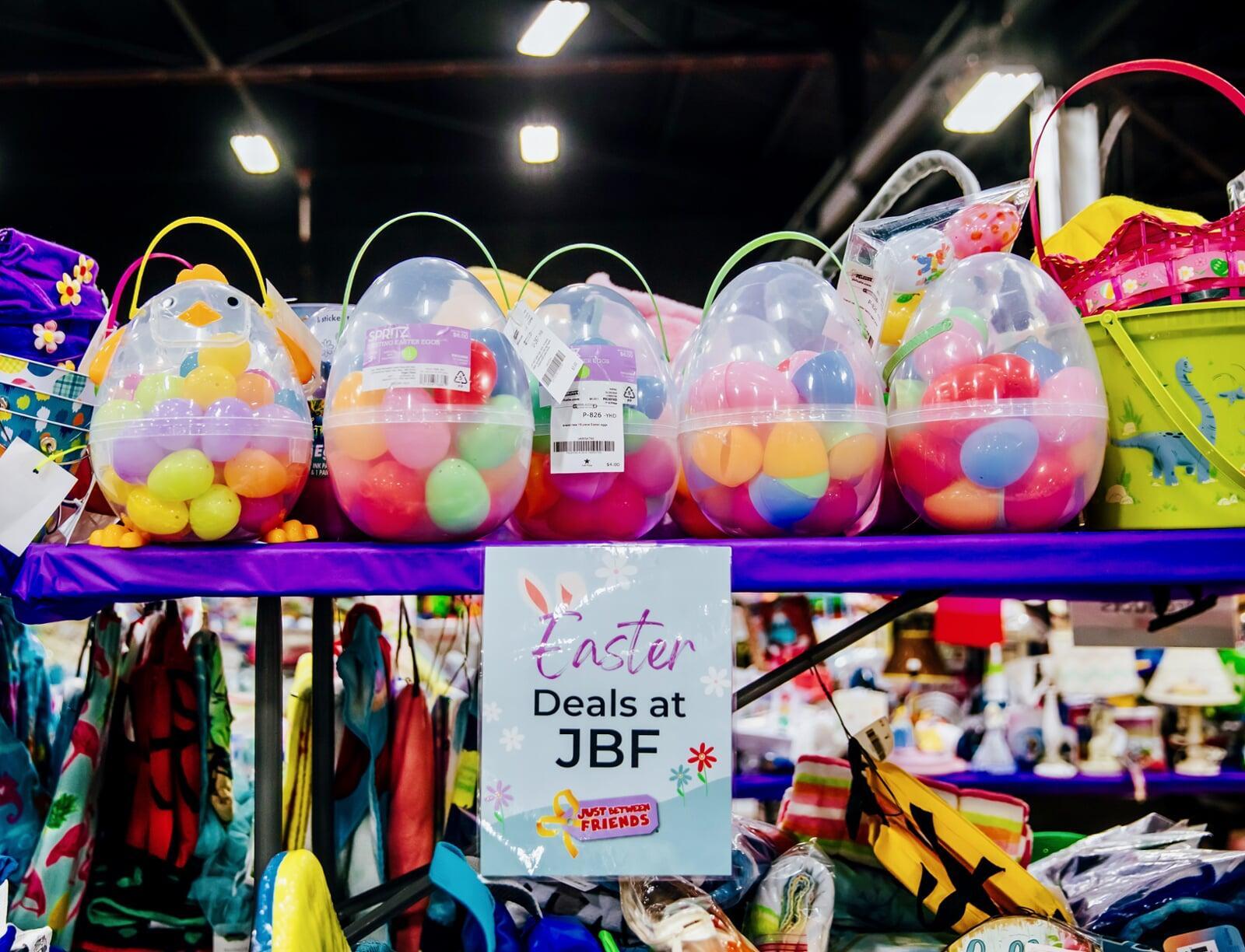 Easter baskets and colorful Easter eggs lined up on tables for sale.