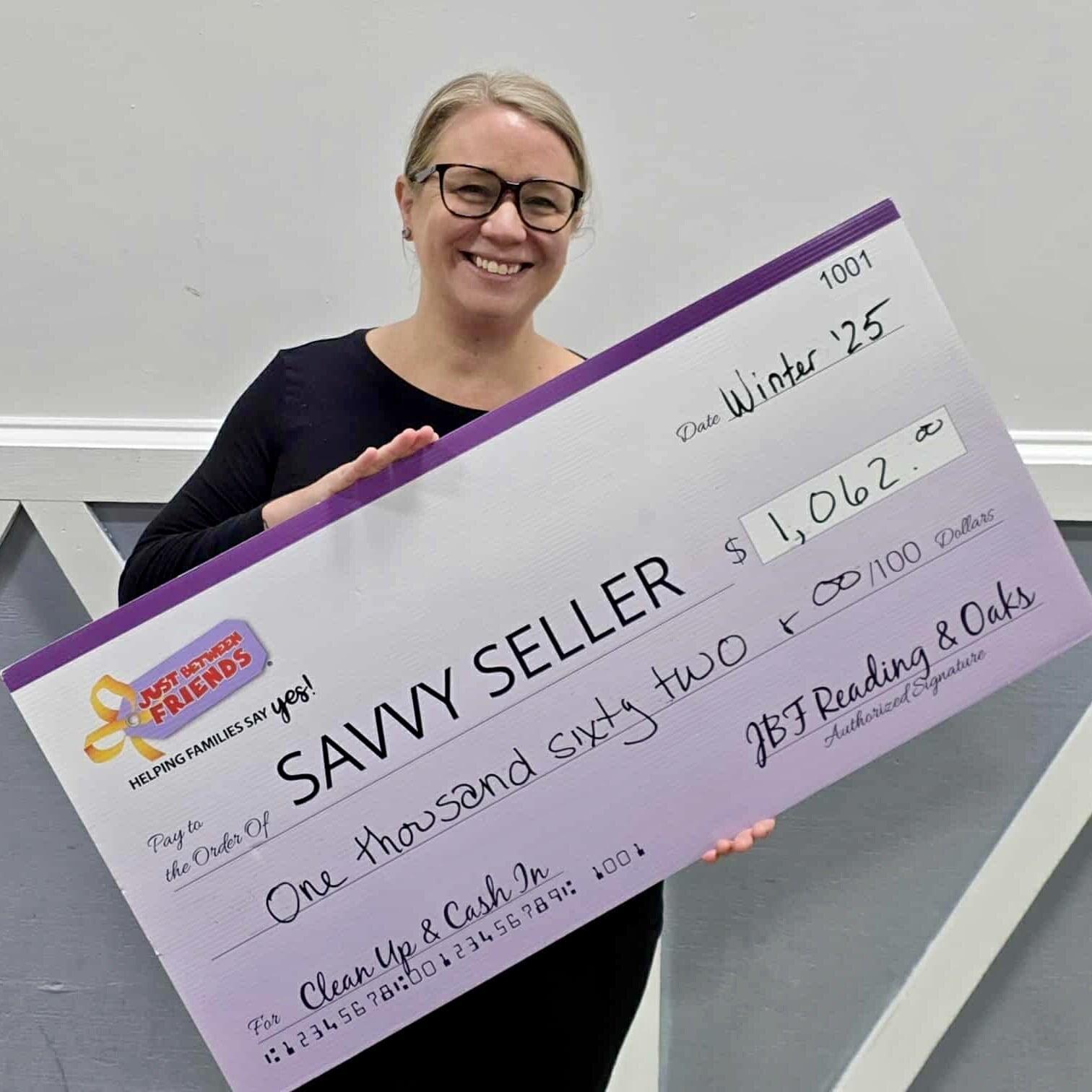 Woman holding a giant consignor check