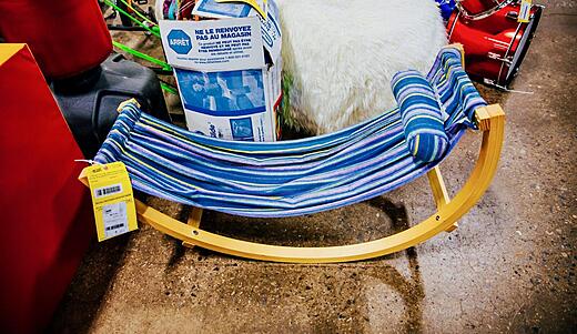 Blue striped hammock on wooden stand